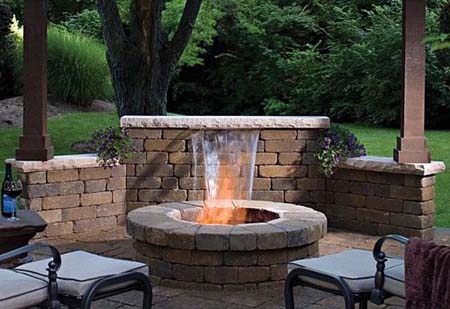 Brick patio with water feature and fire pit.